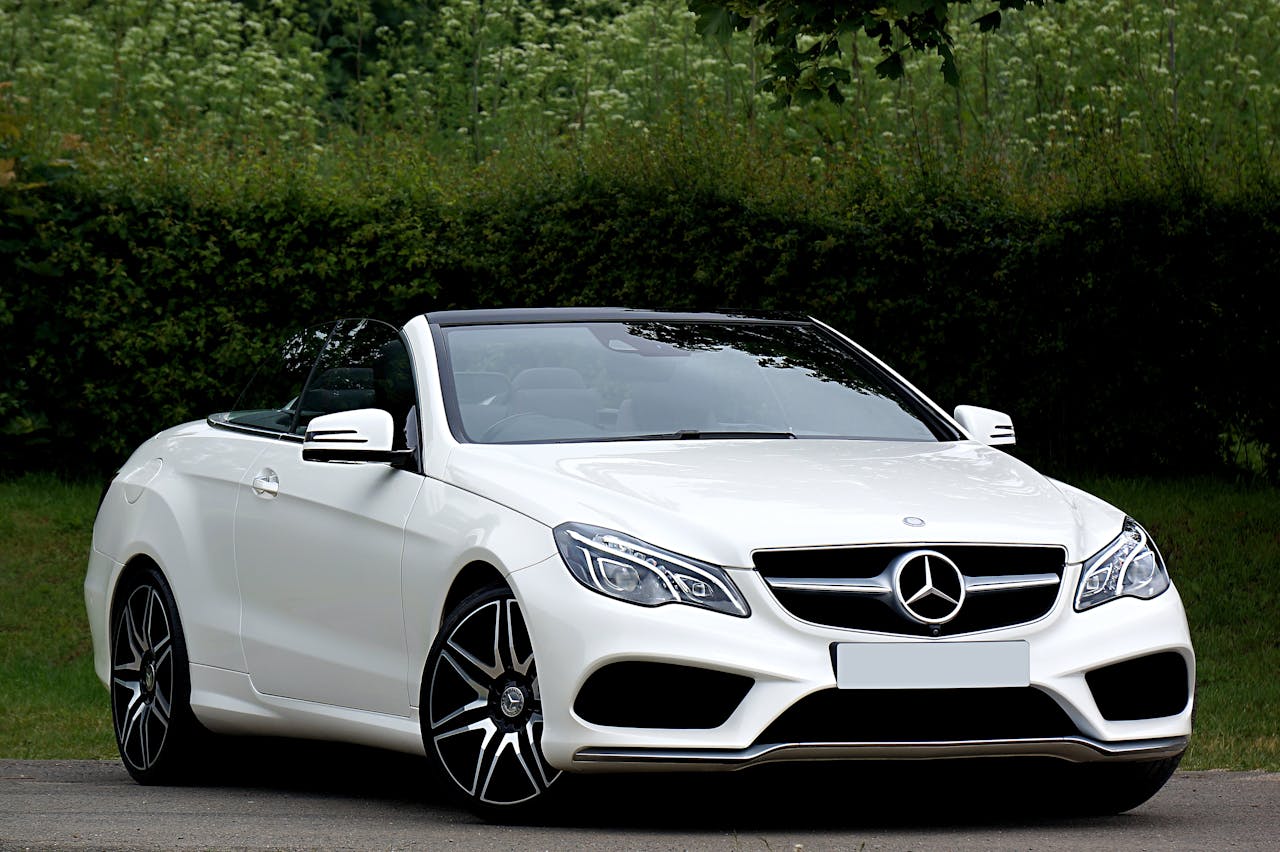 services-06 White Mercedes Benz convertible parked outdoors on a sunny day, showcasing luxury and style.